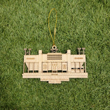 A wooden ornament resembling a stadium, with the text "BYU" visible, is placed on a grassy surface.